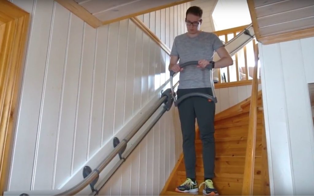 Man uses mechanical stair climbing aid